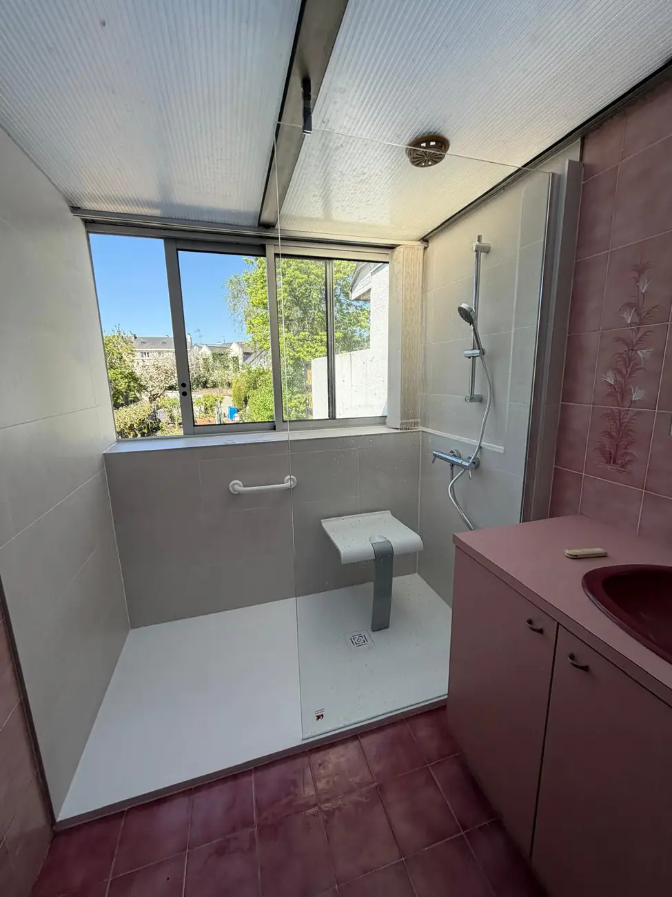Après travaux CP ELEC : douche de plain-pied avec barre d'appui et assise